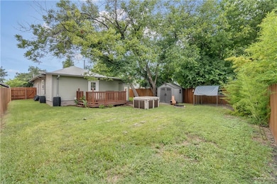 View of yard with a wooden deck and a shed