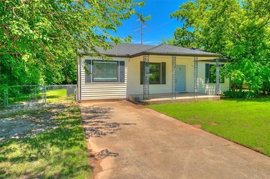 View of front of property with a porch and driveway