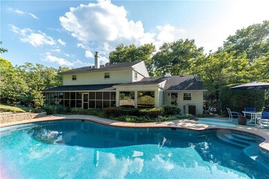 Back of home with Screen in porch, patio and inviting pool
