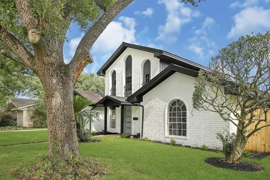 This charming two-story home features a white bric