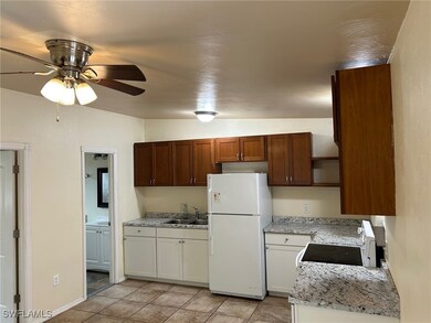 Kitchen featuring white appliances, a sink, open s
