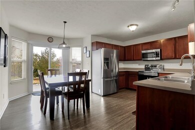 This spacious eat-in kitchen features all newer stainless steel appliances, faucet and flooring