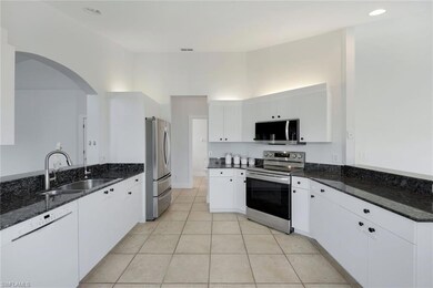 Kitchen with stainless steel appliances, sink, dar