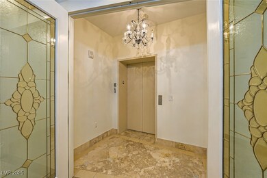 Entryway featuring elevator, light stone finish fl