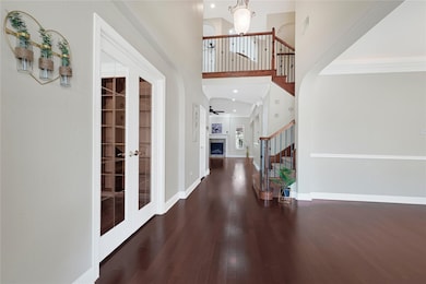 Grand entry with soaring ceilings and hardwood flo