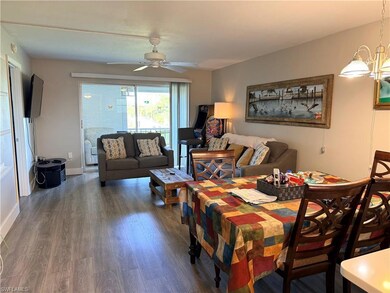 Dining area with dark wood-type flooring and a ceiling fan