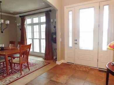 Entering the front door into the 2-story foyer, be