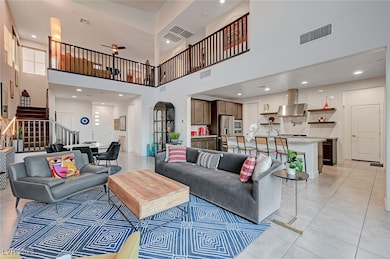 Living area with a high ceiling, stairway, light t