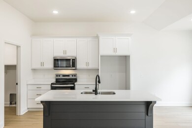 Custom shiplap island is centerpiece to the kitchen, dining and living area