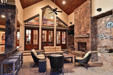 Large covered outdoor patio with Stone fireplace. Outdoor Sound System also provides a wonderful ambiance for relaxation in this space!