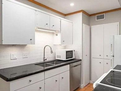 Kitchen with white appliances, a sink, decorative