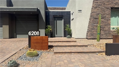 Doorway to property with stucco siding and stone s