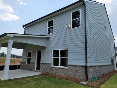 Rear view of property with a patio area, a yard, and brick siding