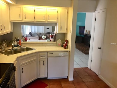 KITCHEN. PASS-THRU TO DINING AREA.ACCENT WALL IN LIVING ROOM HAS BEEN PAINTED OVER