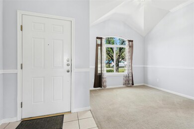 Carpeted entryway with tile patterned floors, vau