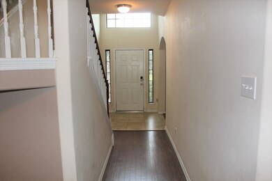 Long entry way with wood floors.