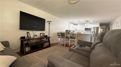 Living area with dark wood finished floors and recessed lighting