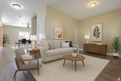 Living room with dark wood finished floors and ceiling fan