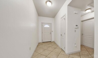 Doorway featuring light tile flooring