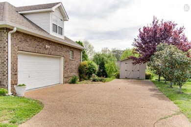 AGGREGATE DRIVEWAY UP TO THE 2 CAR GARAGE AND STORAGE BUILDING