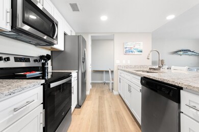 Kitchen with visible vents, light wood-style floo