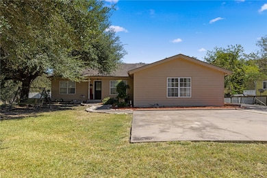 Ranch-style house with a front yard