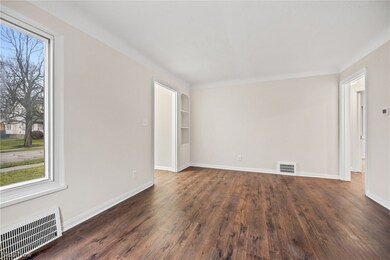 Living room with dark hardwood / wood-style flooring