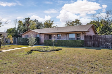 Ranch-style house featuring brick siding and a shingled roof