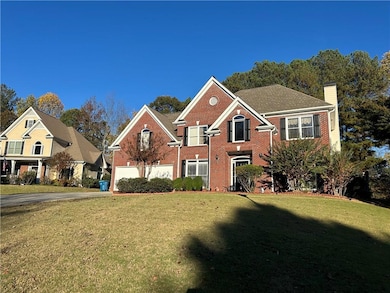 View of front of home featuring a front yard, bric