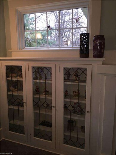 Leaded glass bookshelf in the living room next to 