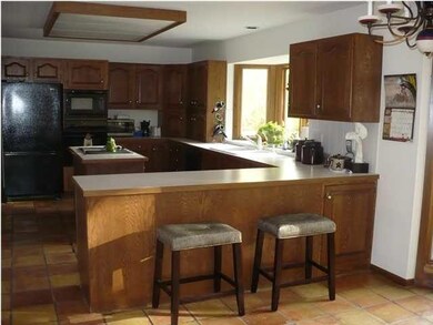 LARGE COUNTRY KITCHEN WITH BAY WINDOW LOOKING OUT 