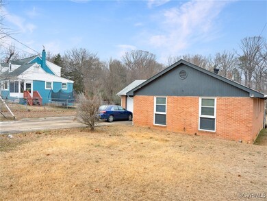 View of side of home with a lawn