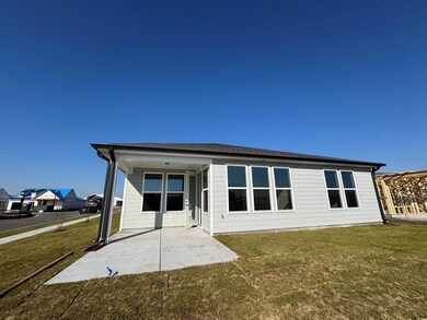 Back of property featuring a patio area and a yard