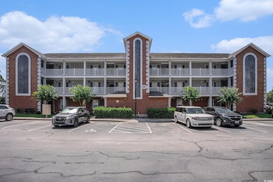 View of building exterior with uncovered parking