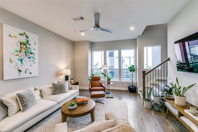 Living room with ceiling fan and hardwood / wood-s