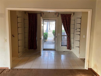 Entryway with light tile patterned flooring