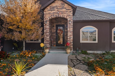 Property entrance featuring stone siding, stucco siding, and roof with shingles