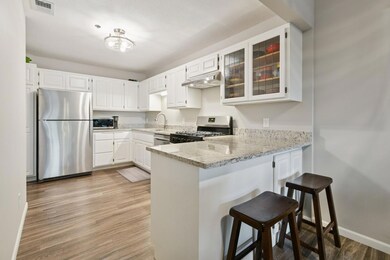 Cute little spot to have a snack on the countertop and underneath the counter there are cabinets which allow for extra storage spots. Here you can really see the all the cabinet space. Paint throughout in 2022.