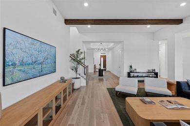 Hall featuring wood finished floors, beamed ceili