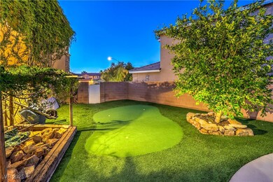 Fenced backyard with a putting green