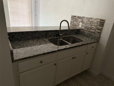 Kitchen featuring a sink, decorative backsplash, d