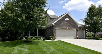 Three car garage and lots of brick accented by  great trees!