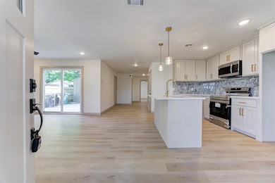Kitchen featuring stainless steel appliances, tast