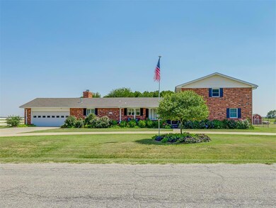 View of front of home with a garage and a front la