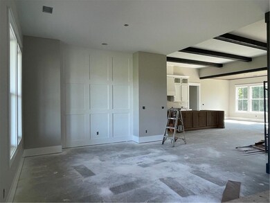 Living room with baseboards and concrete floors