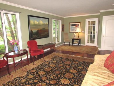 The living room features Brazilian Cherry Hardwood