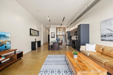 Living area with finished concrete flooring and baseboards