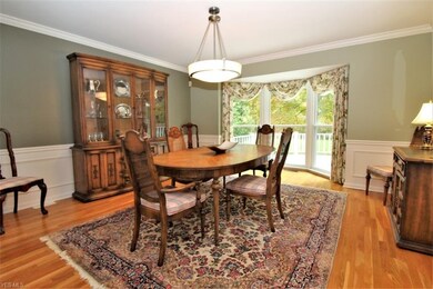Hardwood flooring and a lovely window bay enahance