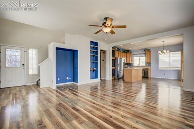 Unfurnished living room featuring baseboards, stai