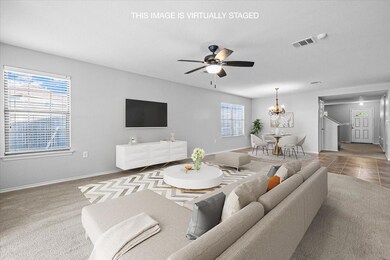 Living area with visible vents, baseboards, and c